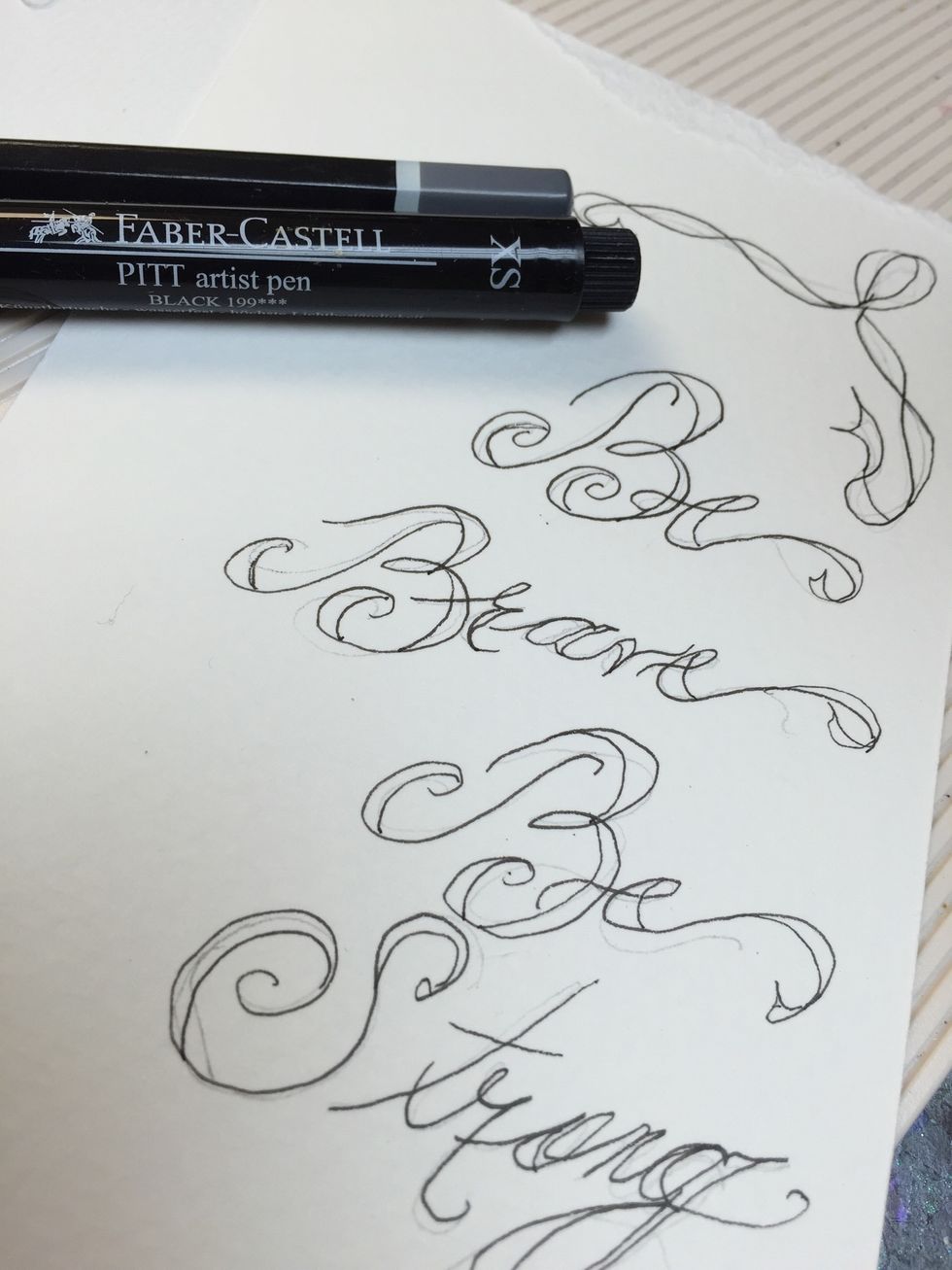 I free hand my calligraphy and I use a Pitt Artist Pen, it's waterproof and perfect!