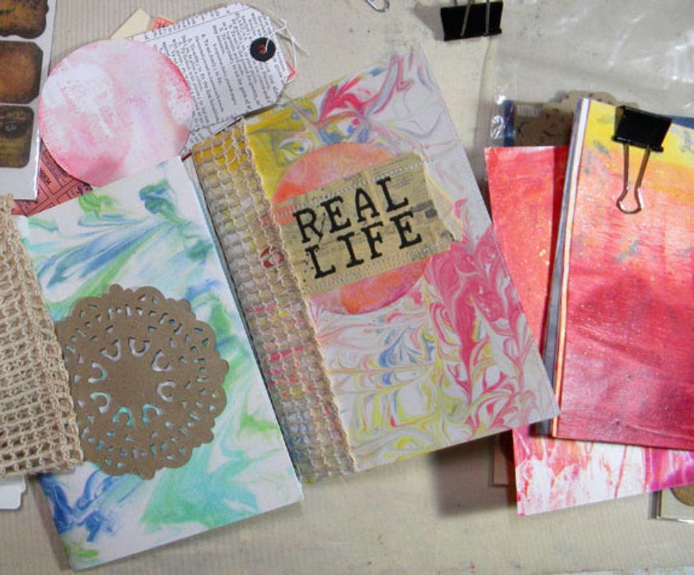 I gathered die-cuts, tags, ribbon, stamps and chipboard embellishments and went to work sewing, glueing, stamping and individualizing each journal.  I used my sewing machine to bind the pages.