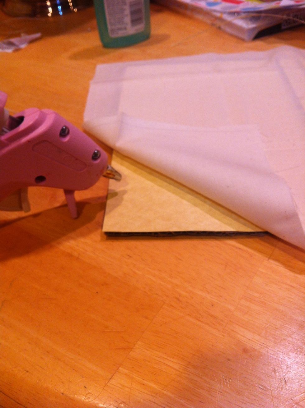 I glue my cover done with a hot glue gun. (I added some paper to my cardboard since my fabric was see through.)