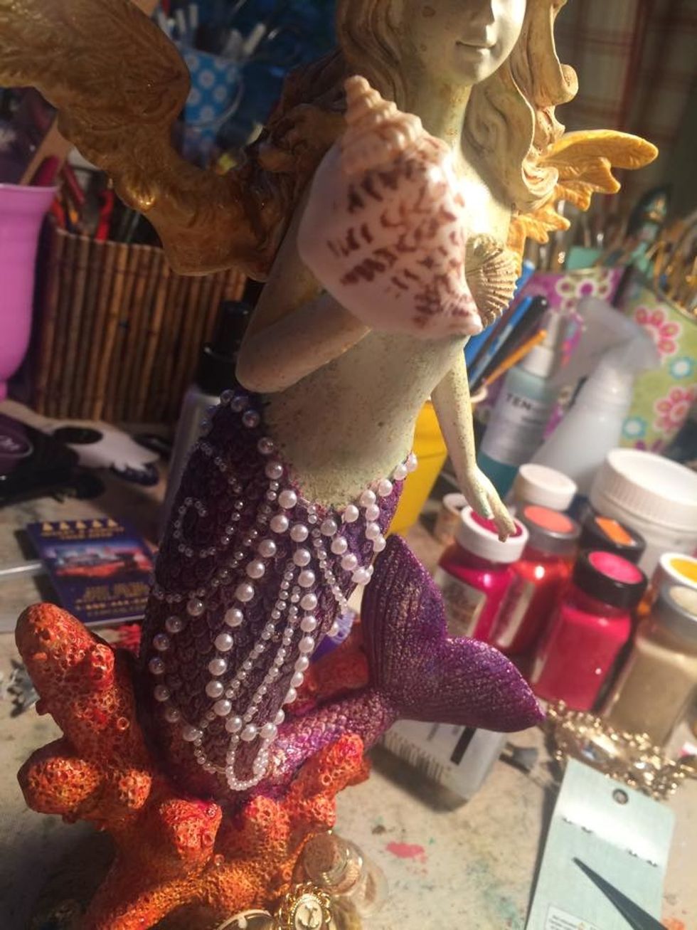 I glued a larger shell where her hand is missing. I am not a sculpter so I had limited options. I like how it worked out though. Sometimes you just have to make it work with what you have :)