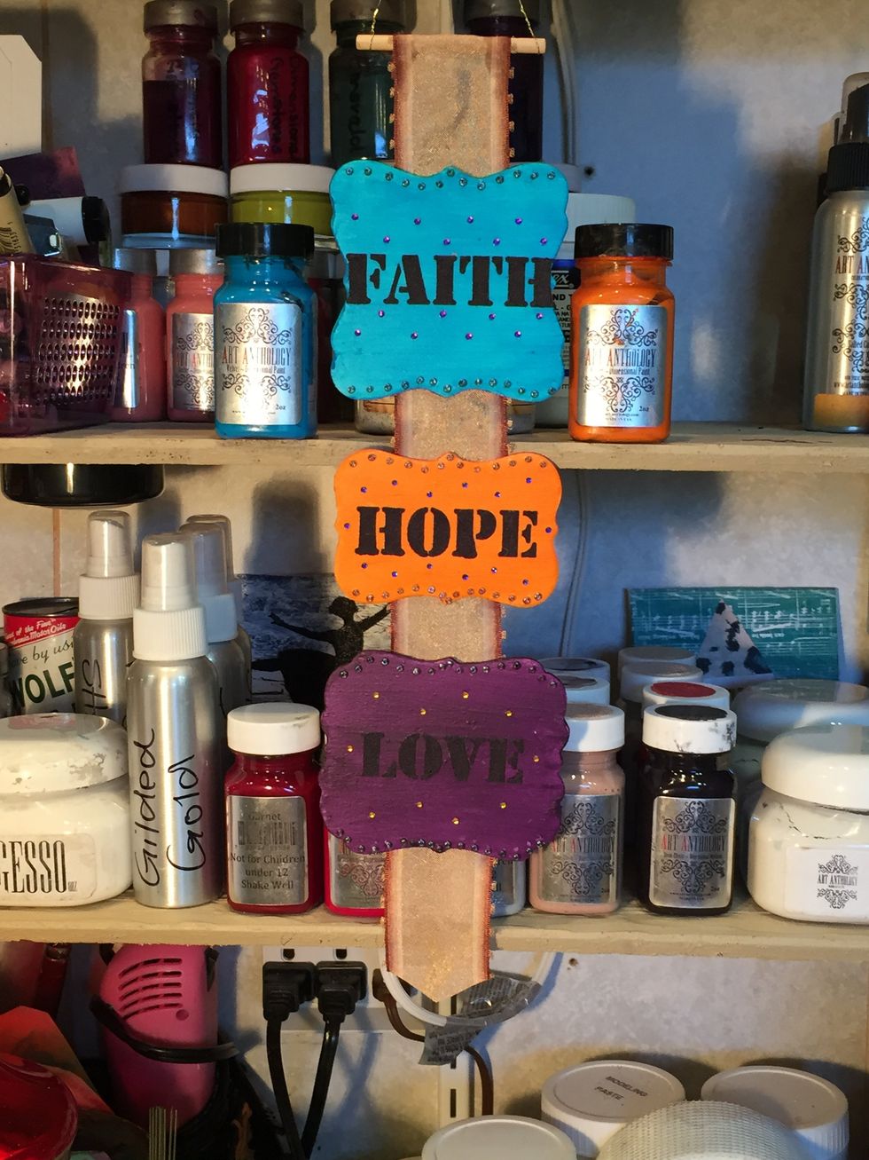 I glued my plaques to a piece of ribbon and then looped one end over and inserted a piece of dowel. I then used wire to create a hanger. At this point, I really didn't like what it looked like.