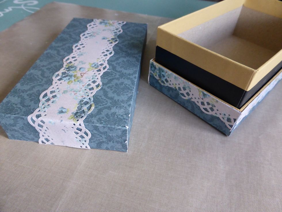 I glued the papers to the box. With the large double lace strip on the top of the box and the smaller lace strips around the edge of the bottom part of the box.