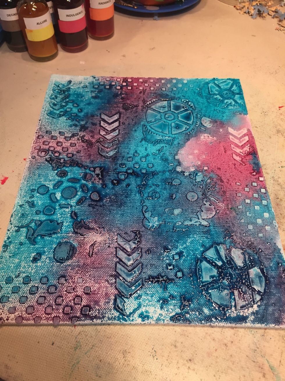I got a little carried away & forgot the first photo. Take Mud & stencil it through sections of the Blocked, Tick Tock, & Mechanical stencils. When dry, spray with Peacock Feathers & Wild Orchid.