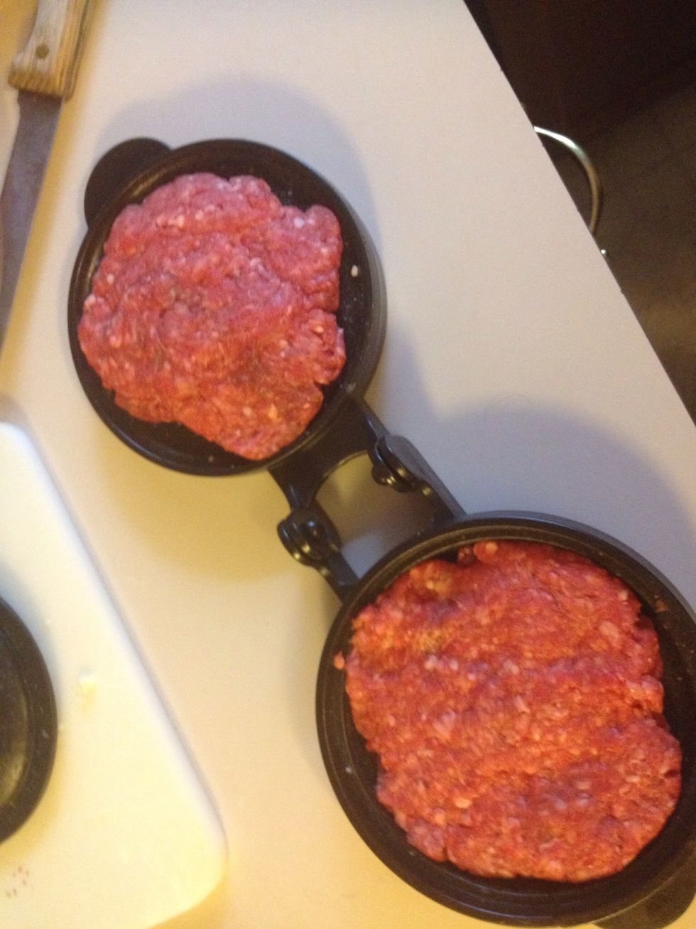 I got this burger press from William Sonoma for $15. Divide you 1/2 lbs balls into two and press out into two patties. A little oil helps it not to stick!