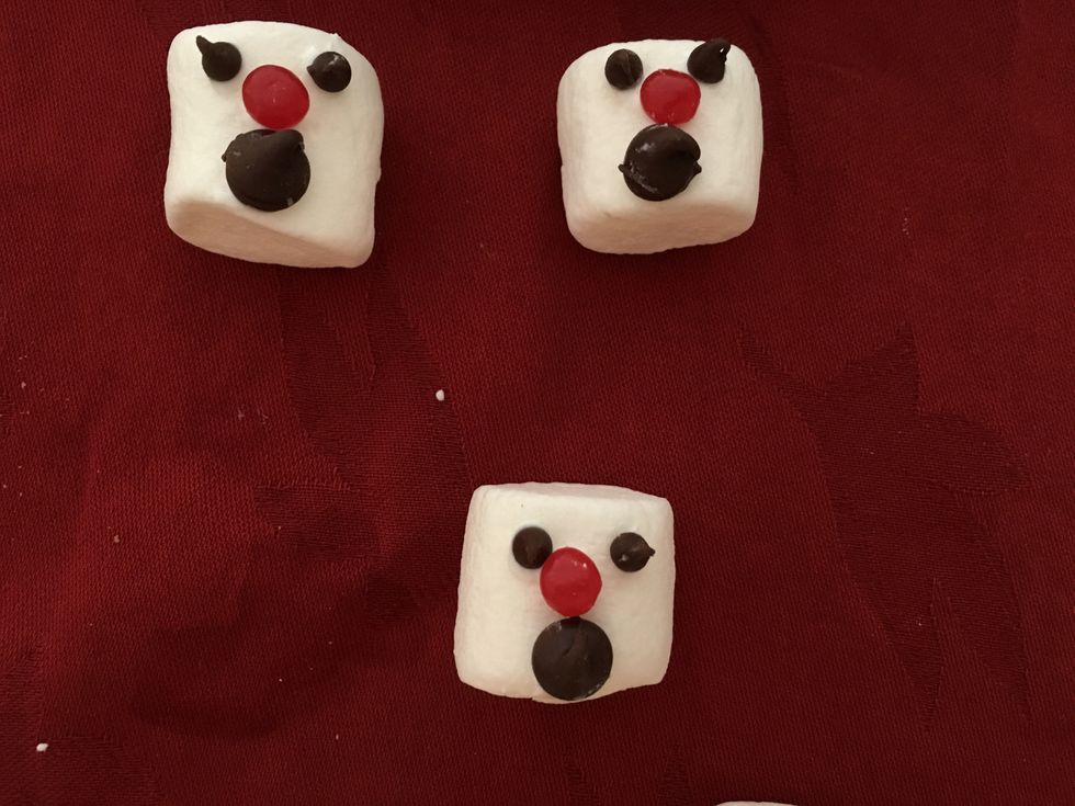 I had best luck when I prepared the heads before baking the cookies.  The eyes, nose and mouth stayed in place better that way.