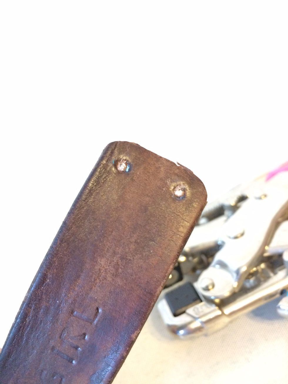 I had the stamps that were made to stamp metal, so it didn't turn out that good.  Next, I punched holes out of the end of the bracelet.