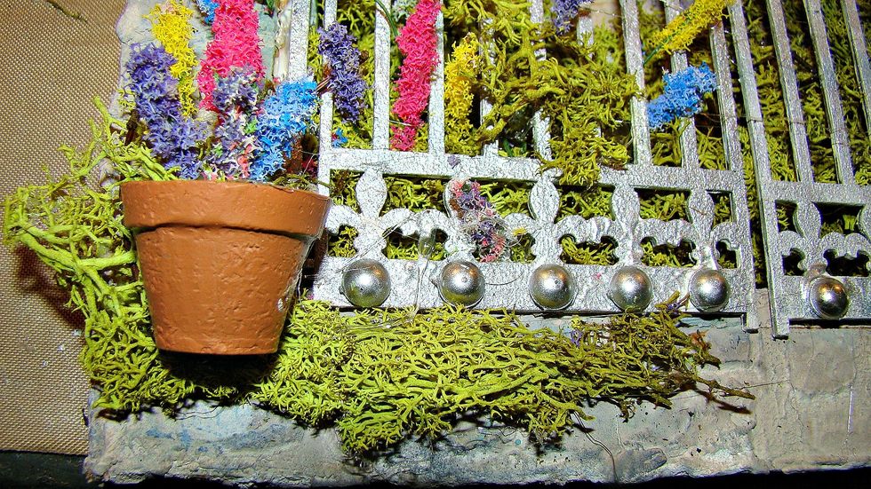 I had this teeny tiny terracotta pot so I adhered it to the canvas, filled it with the moss and added some of my blooms