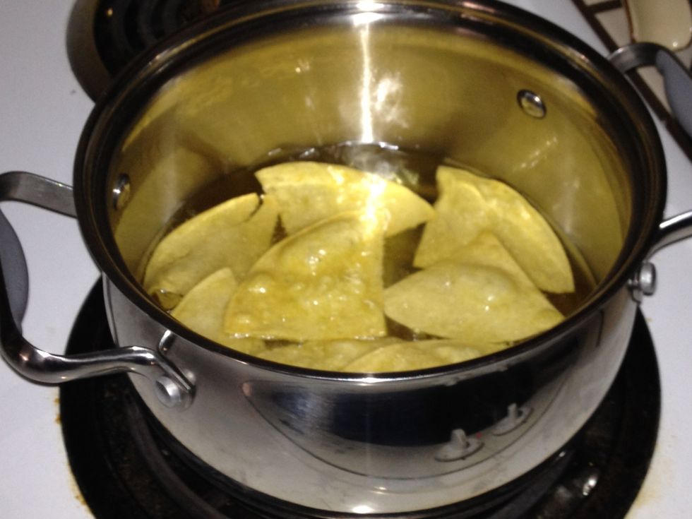 I have divided the tortillas into 4 quarters. Oil heat should be between medium- high, cook until light golden brown wait until 2-3 minutes before removing from the hot pot.
