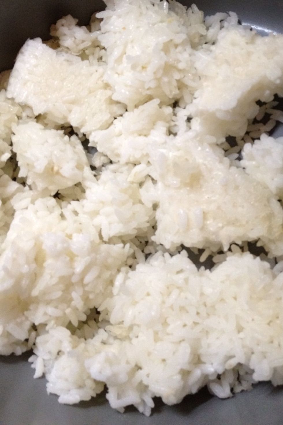 I have some short grain white rice that has been sitting in the refrigerator so I'll break it up and put it in a pan on the stove.