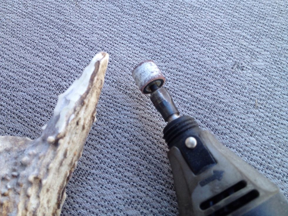 I have started to sand down the tine to make the letter opener blade. Go slow and use even strokes. Don't keep the drum sander in one place for long or you might take off too much material.