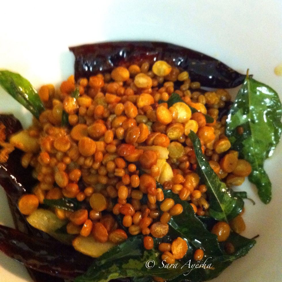 I have taken 2 tbps of oil and fried them in this order.. Dry chillies, chana dal, urad dal, cumin seeds, coriander seeds, fenugreek seeds,garlic,curry leaves.