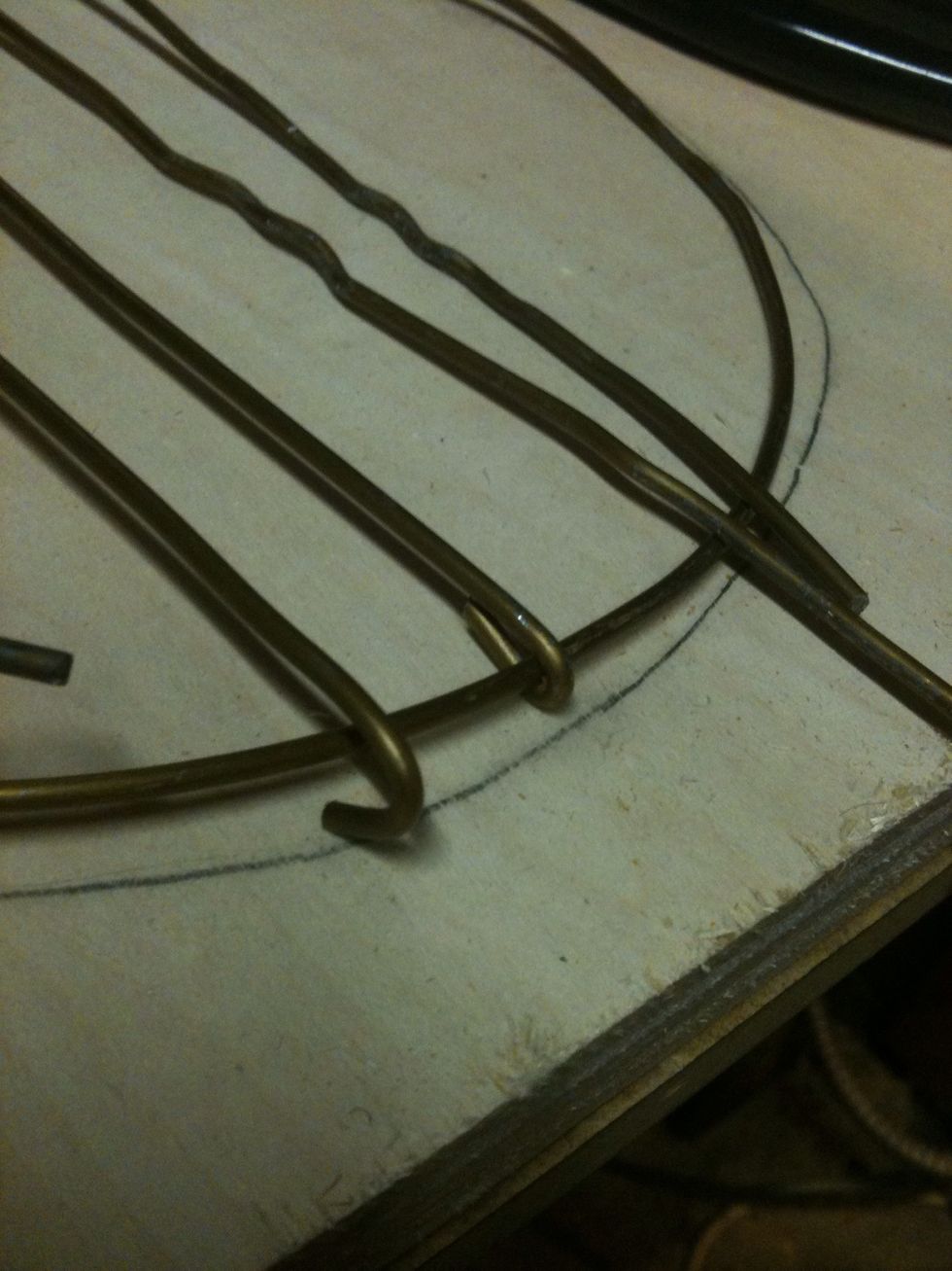 I hooked the wire around the circle as shown. I spaced them about 5/8"-3/4". Once I did one side I started hooking the other side trying to keep a 7" circle.