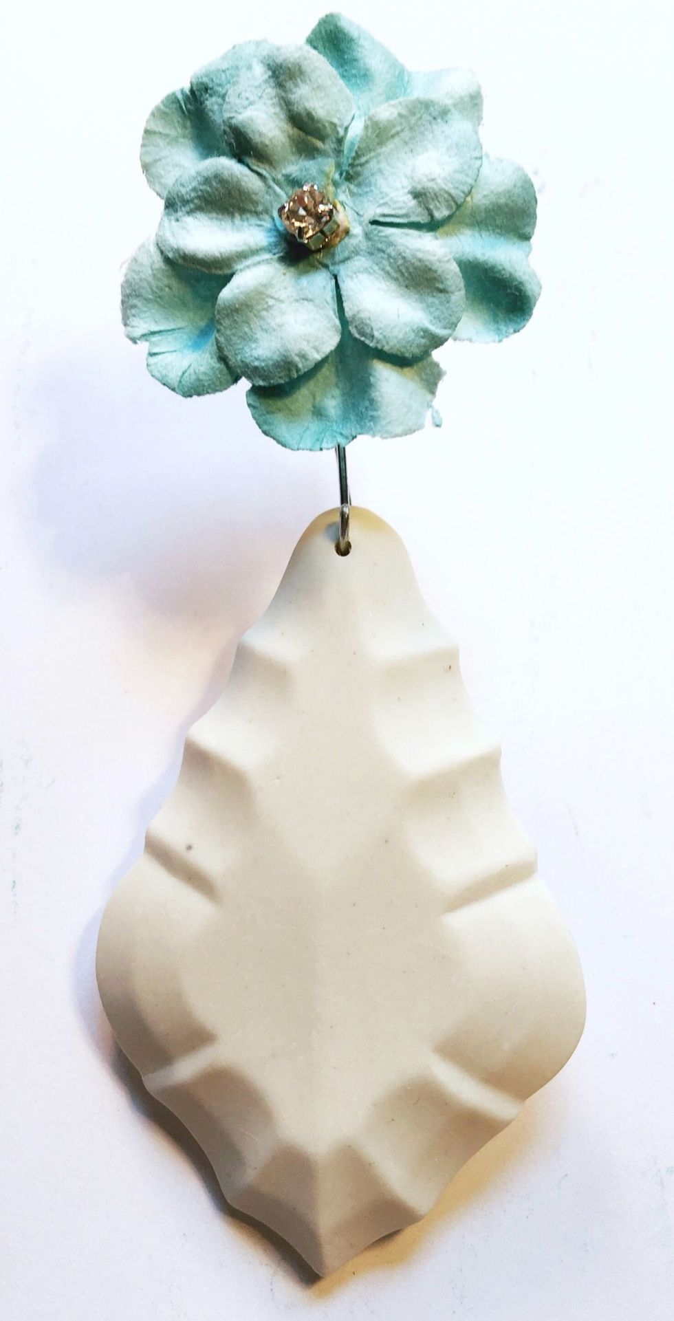 I hot glued one of the smaller Prima flowers to the flower on the pendant. I replaced the centers of the flowers with a rhinestone