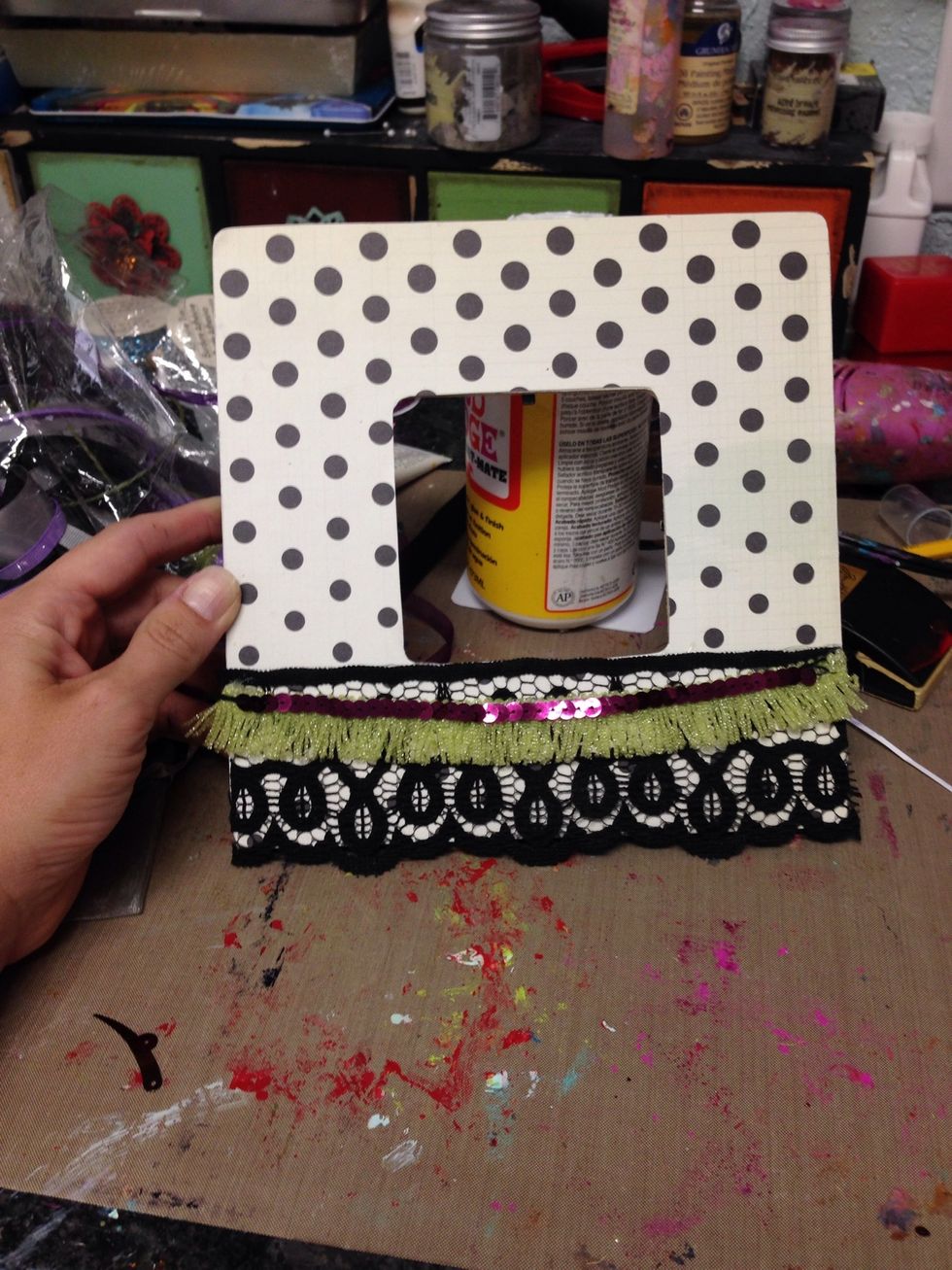 I hot glued some colorful trim pieces to the bottom of the frame