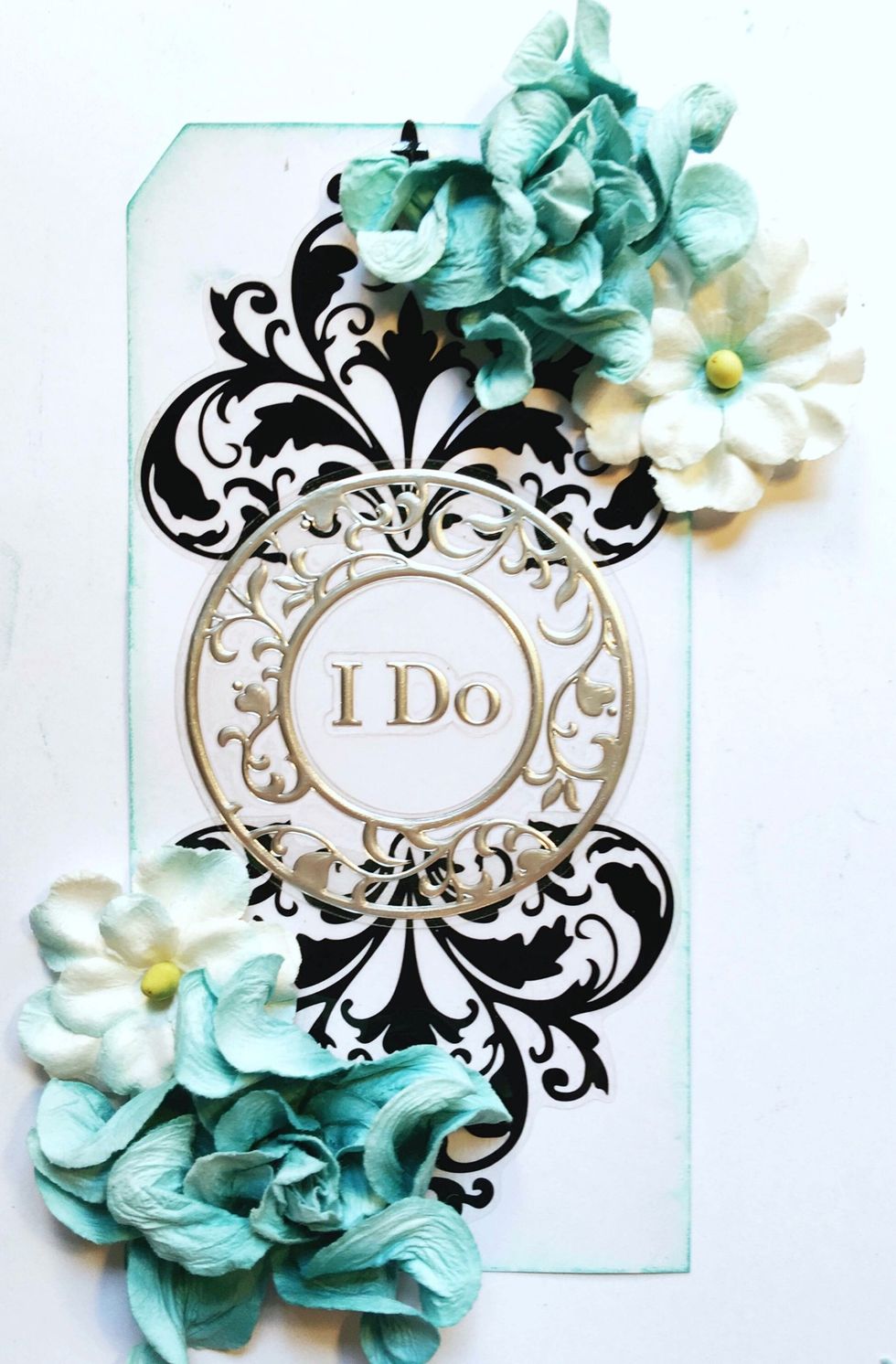 I hot glued the Prima Flowers (French Riviera) to the upper right and lower left corners of the tag