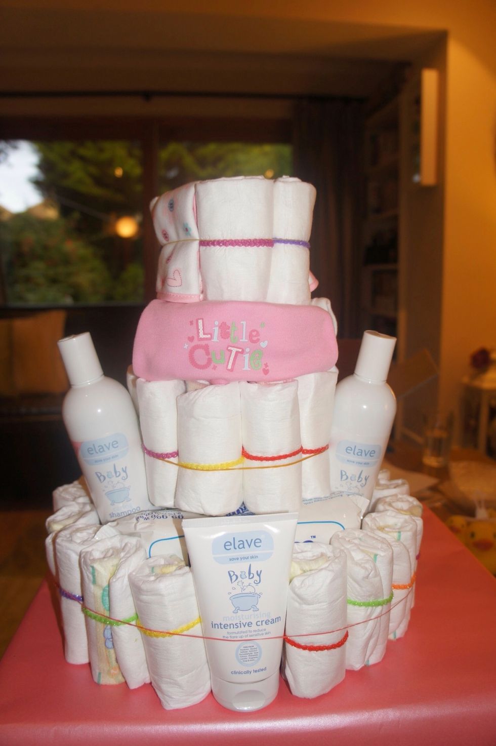 I jammed in some baby wash and lotions to make sure the Champagne bottle was fully secure. I also decided to replace some nappies with folded bibs to make it prettier! :-)