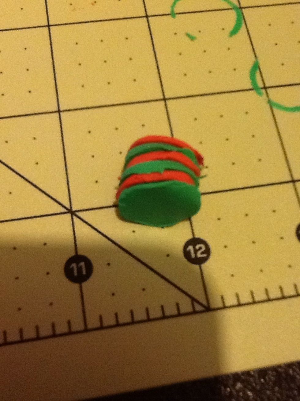 I jumped a bit but now you can go ahead and condition, roll, and make circles with second color. After that layer them to your liking. Then gently press the top then roll the sides.