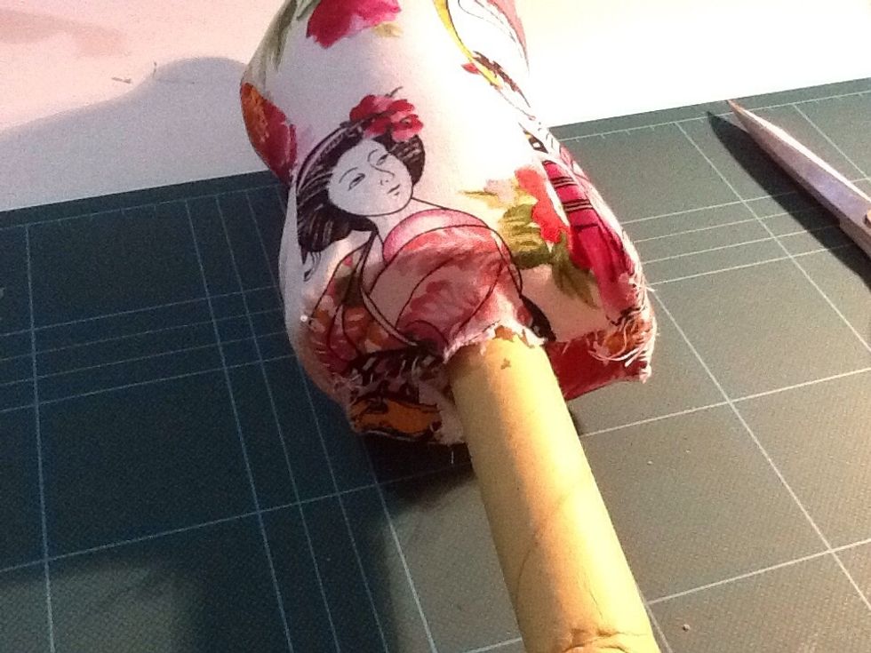 I just got my fabric scissors and chopped through the fabric and the cardboard, and pushed the cardboard roll up until it almost reached the neck of the "woman".