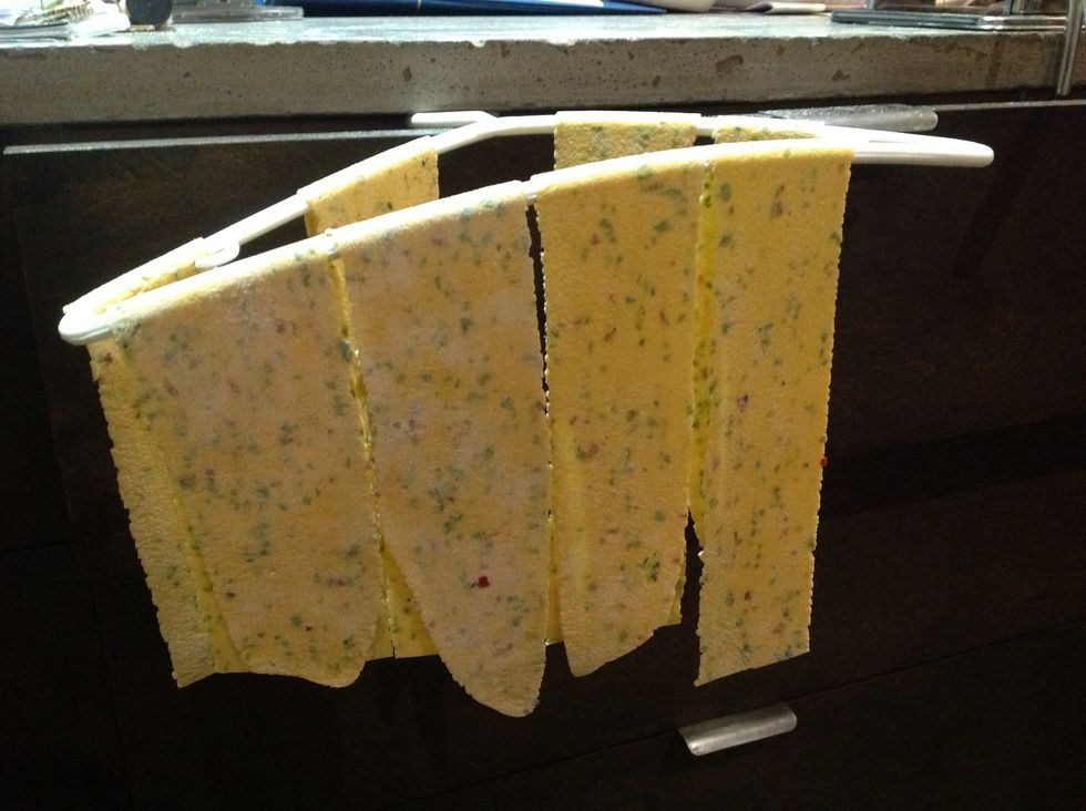 I just used a coat hanger to hold the sheets of pasta away from themselves and each other while I was working so they wouldn't stick together. Work quickly so they don't dry out too much while u work.