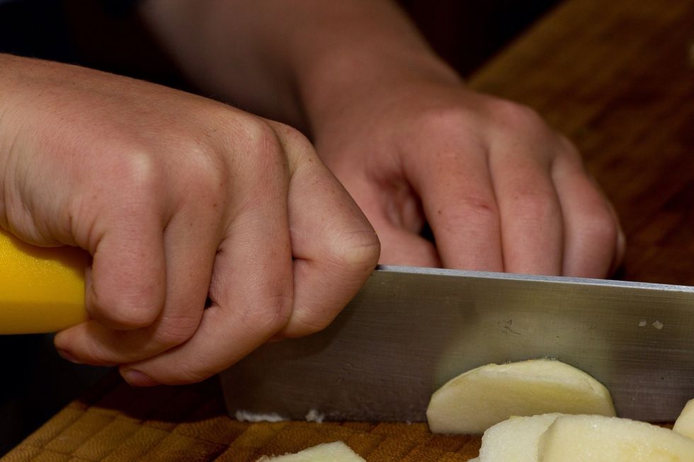 I keep both hands in contact with the blade at all times so the knife doesn't slip and cut me. Notice my thumb is safely tucked away too.