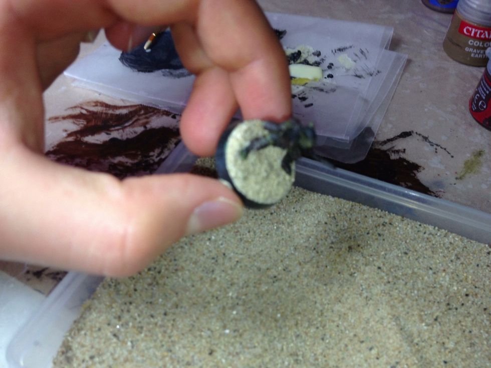 I know this picture is slightly out of focus, but I think it's pretty clear what's happening. Tip the base so some of the sand falls off.