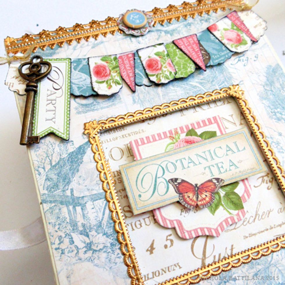 I layer tags, banners and chipboard to the front and sides of the box. Make sure to keep the front design quite flat. Remember, when open, this is the floor of your shop!