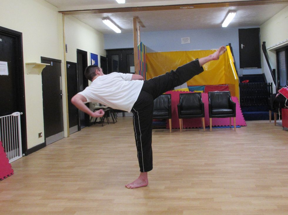I lean back at the waist which raises the hips. I extend the hip and knee across the face of the target in a hooking action. My body has twisted into the attack.