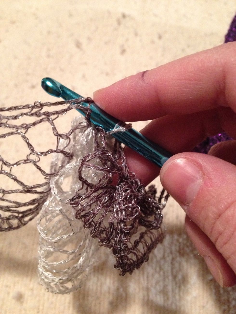 I like my scarf sections tight so I begin on the closest space, skip a space and then add 8 or 10 loops so you always pull the last through and leave a single loop on the hook.