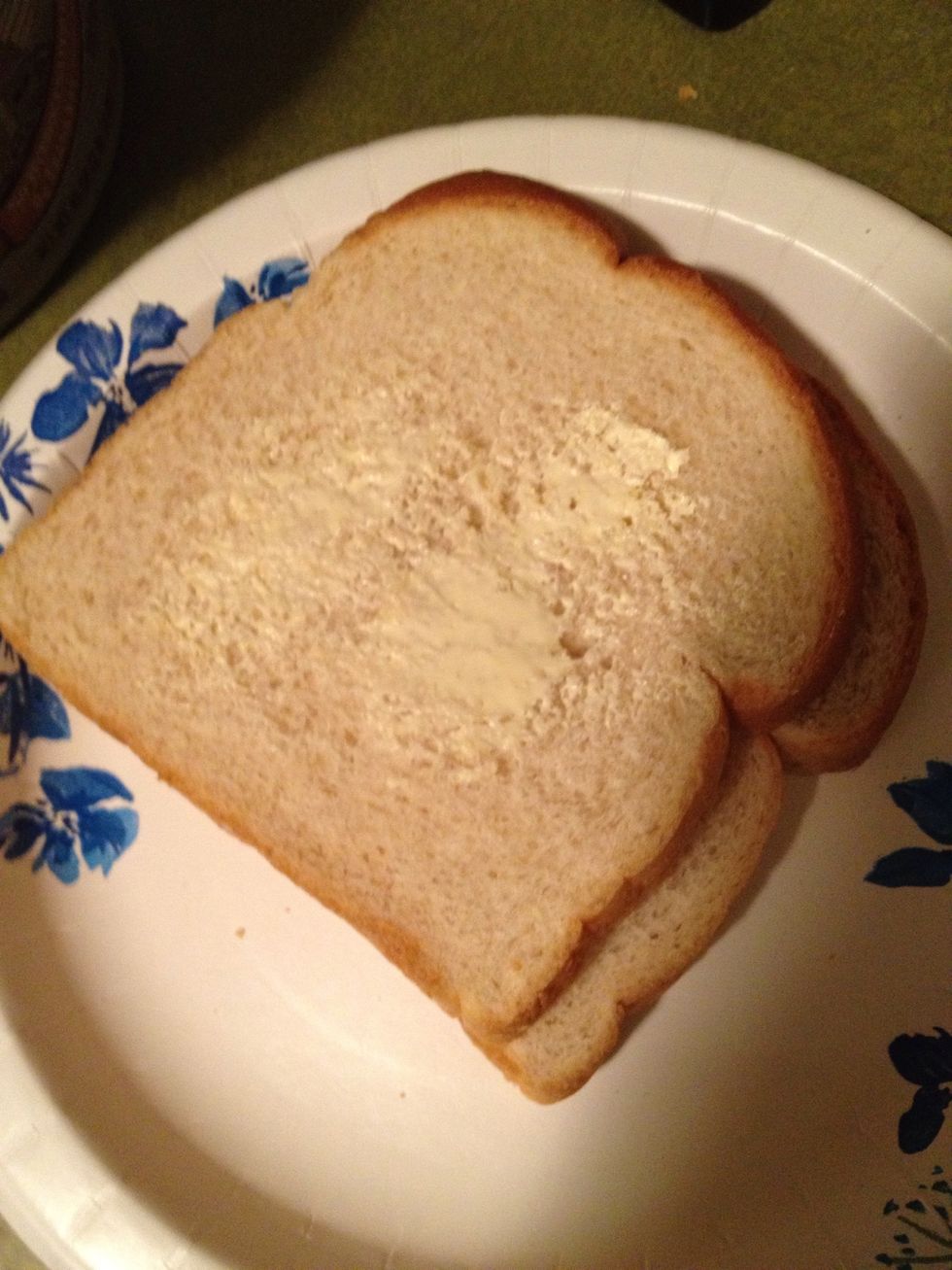 I like to butter the middle before adding the bread into the egg mix. This is the part that is more likely to stick to the pan. This is optional.