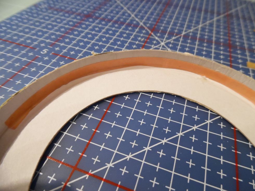 I like to make sure any visible edges are neatly finished. The edge of the brim was to high and to thin. Add a piece of Red Liner tape and roll over the edge of the brim onto the double sided tape.