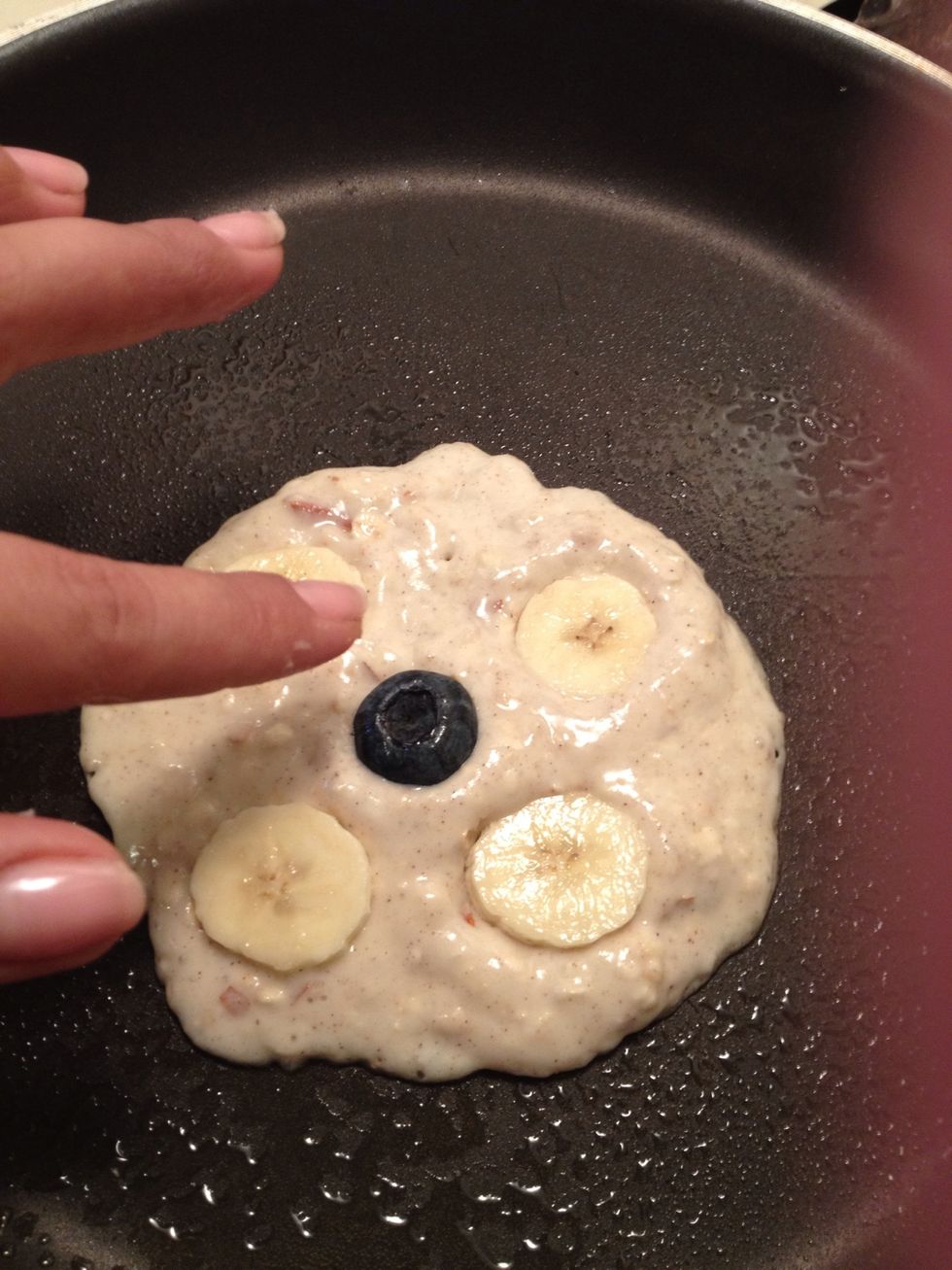 I like to place a bigger blueberry in the middle. Press down into batter...