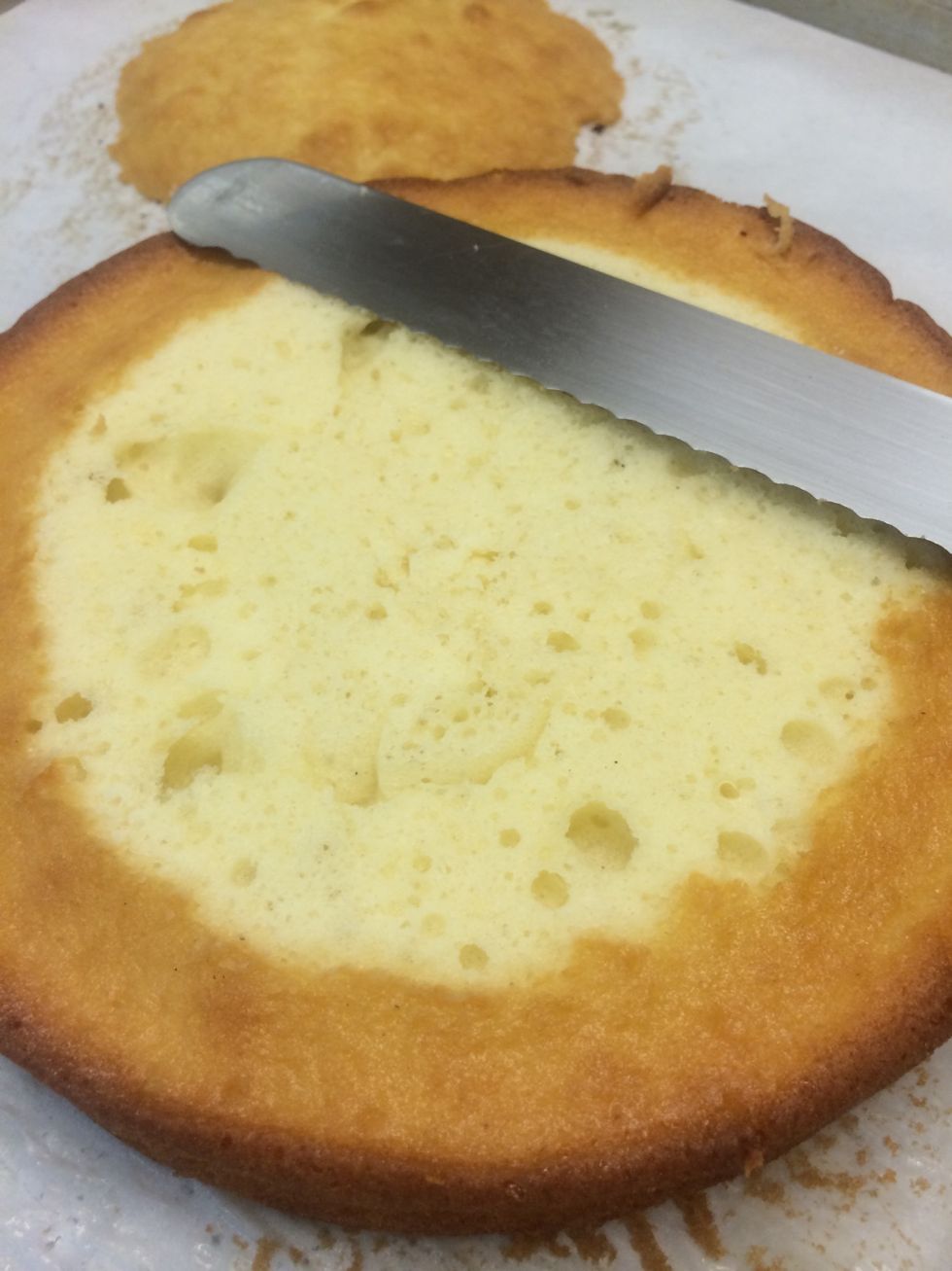 I like to slice the tops off of the cakes to flatten them out a bit. It also serves as a snack while your decorating the cake.