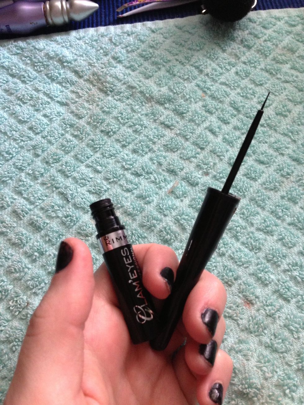 I like to use a liquid liner with a tapered brush applicator. I feel like it gives me more control and a more defined look.