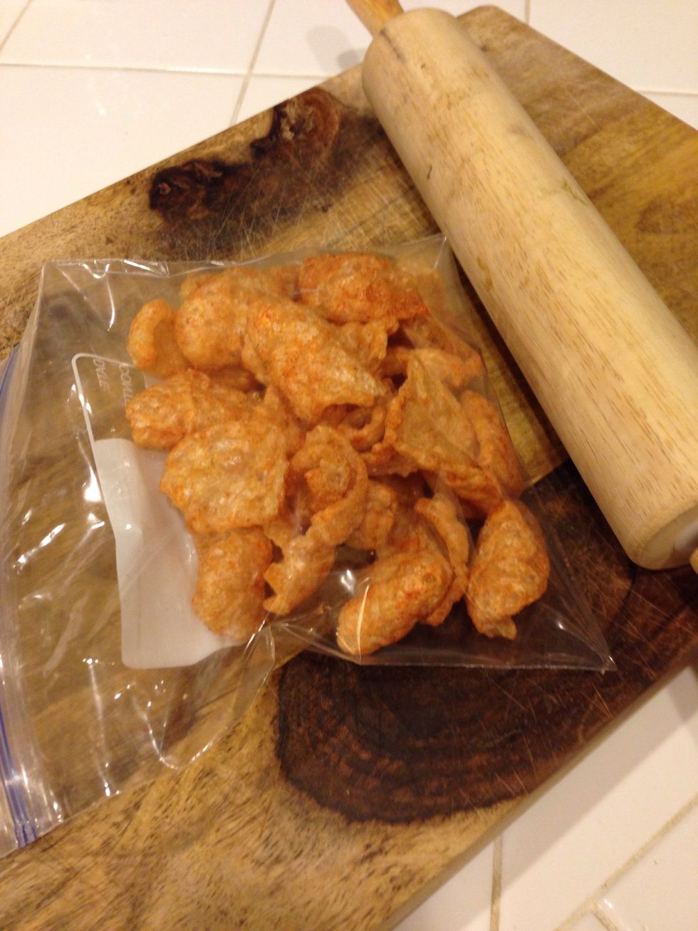 I like to use spicy fried pork skins, but feel free to use the original flavor. Add pork skins to a ziplock bag and smash with a rolling pin.