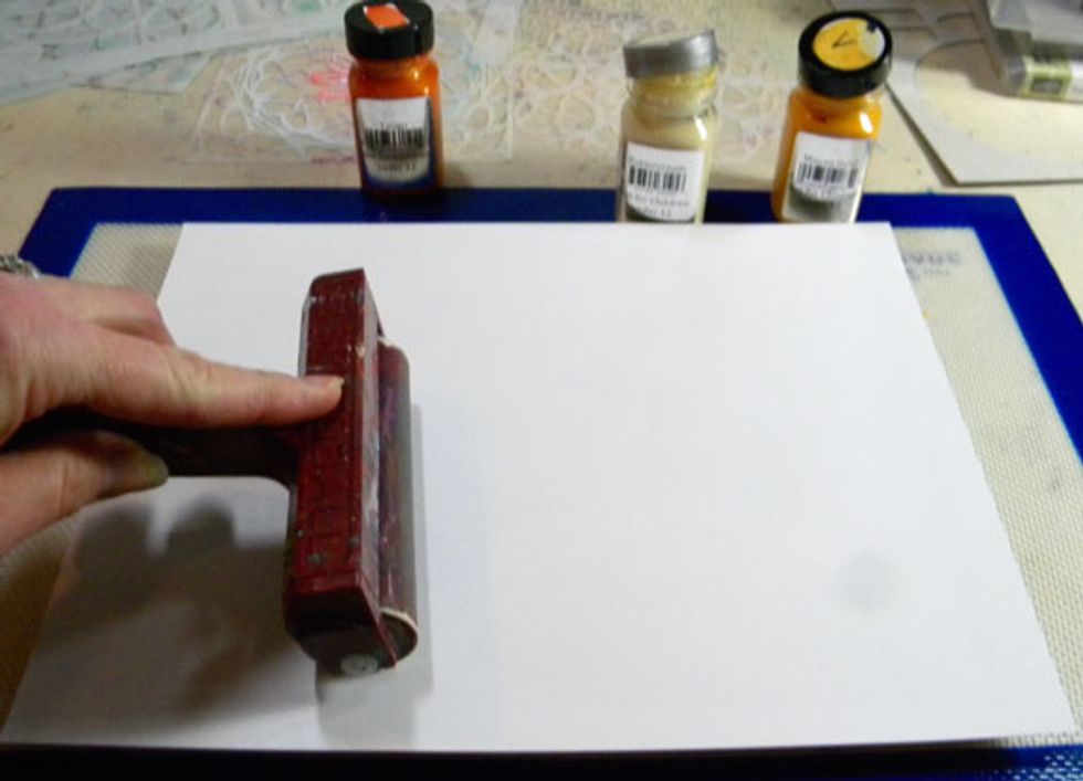 I like to use two brayers; one to spread the paint and a clean one to smooth the paper onto the plate to make sure the paint makes contact with the paper.