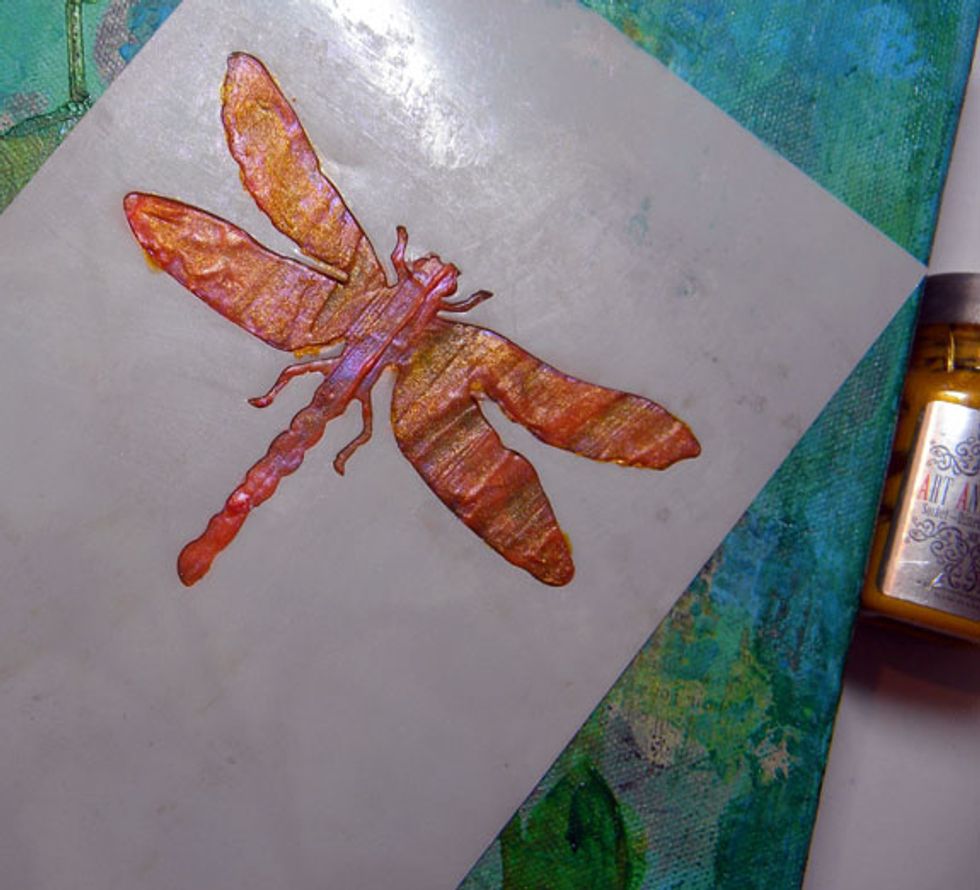 I line the stencil up with the dragonfly to protect the background and applied paints and sprays until I like the results.