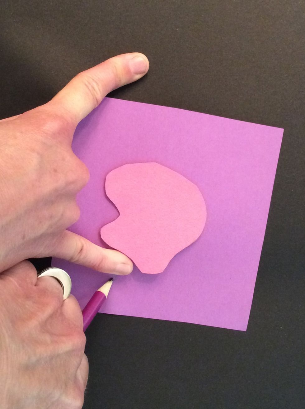 I'll choose a larger paper in another color and measure one pinkie width away from my first shape.