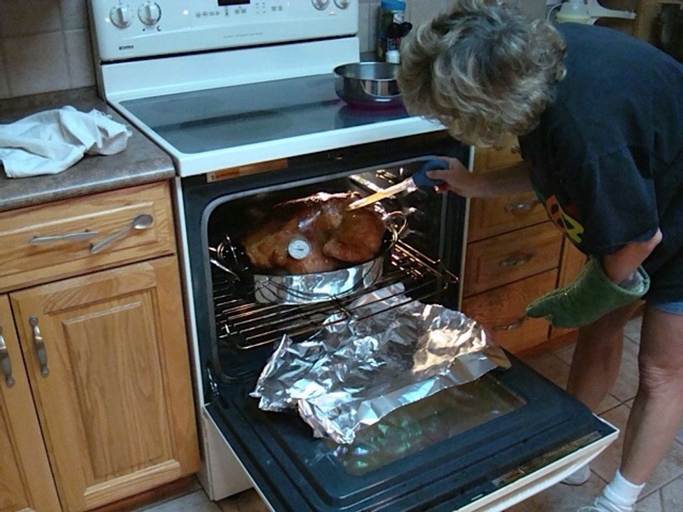 I loosely cover turkey so it doesn't dry out or over brown & baste drippings over once per hour or so. Use thermometer to be sure it reaches 185\u00b0 inside.