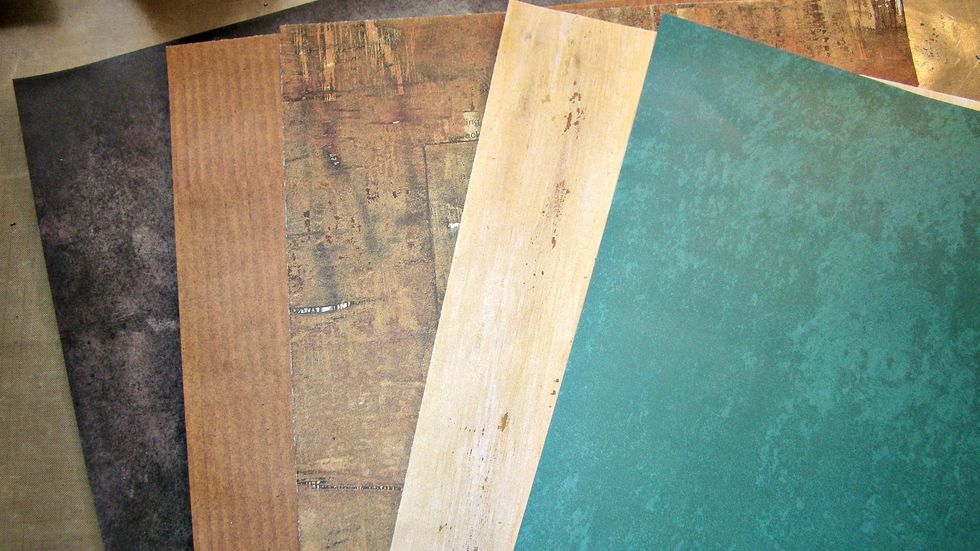 I love to layer my papers. It adds interest, textures and can bring out pops of colors to enhance your layout. First choose the palette of colors you want to use. I chose 5 different papers.