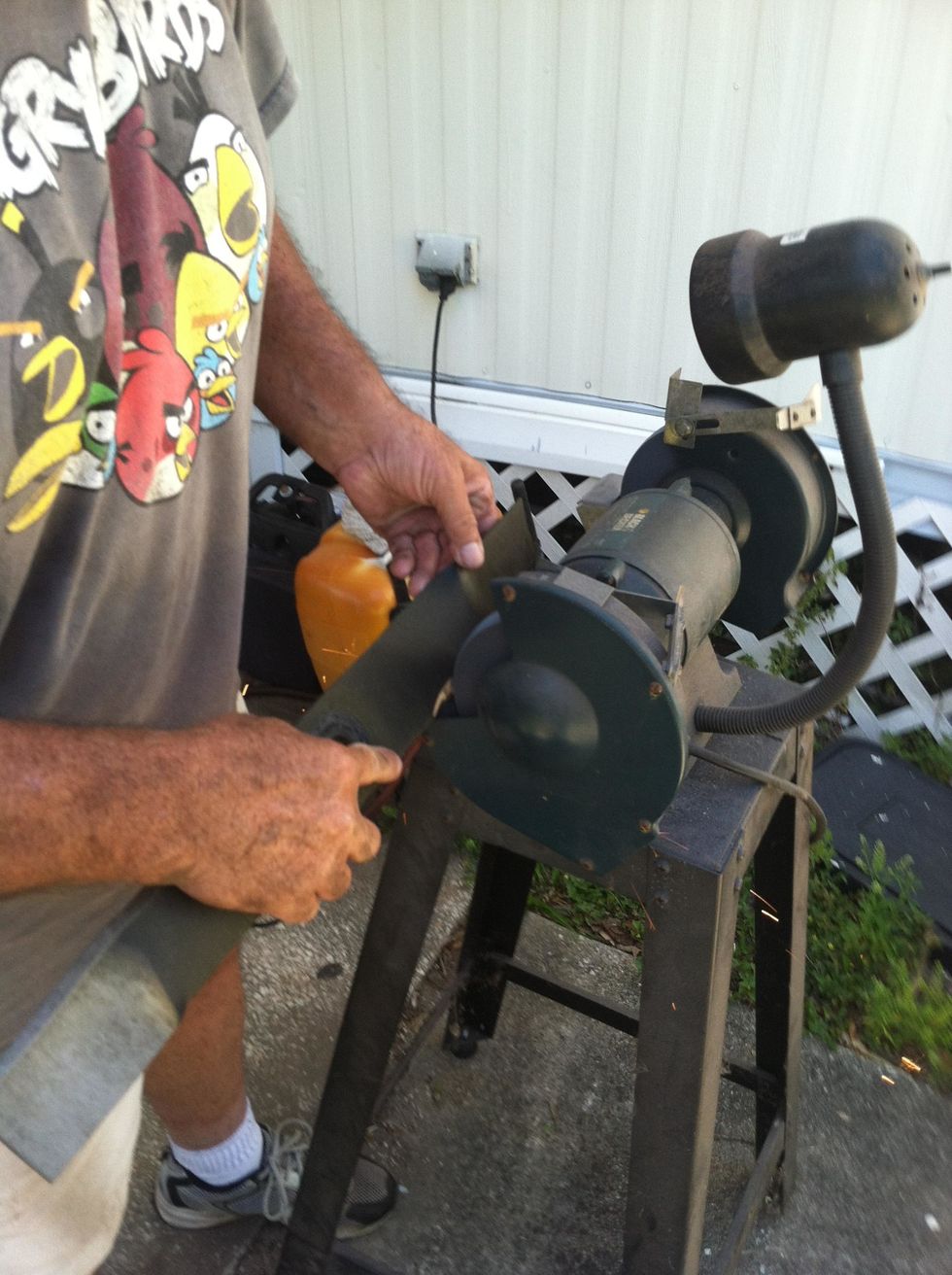 I'm going from the center of the blade to the end of the blade, one side at a time, the cutting edge of the blade is contacting the wheel through this entire process