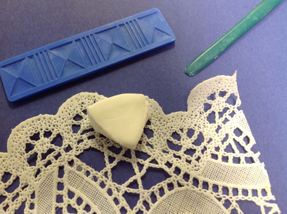 I'm going to press some texture in the clay using found things.