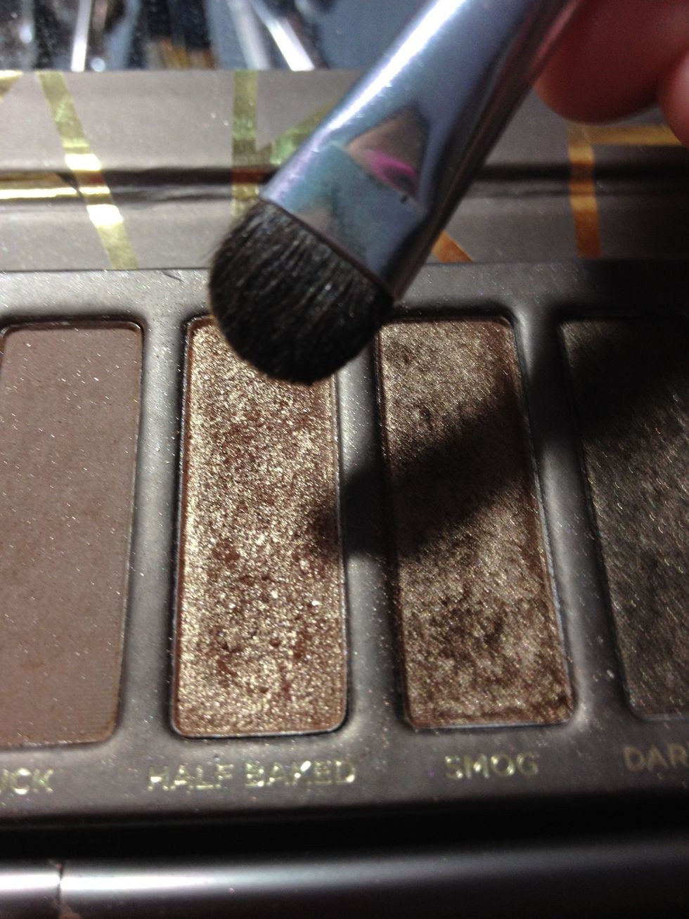 I'm going to use this stiffer, flat shadow brush from e.l.f to apply "Half Baked" on my lid