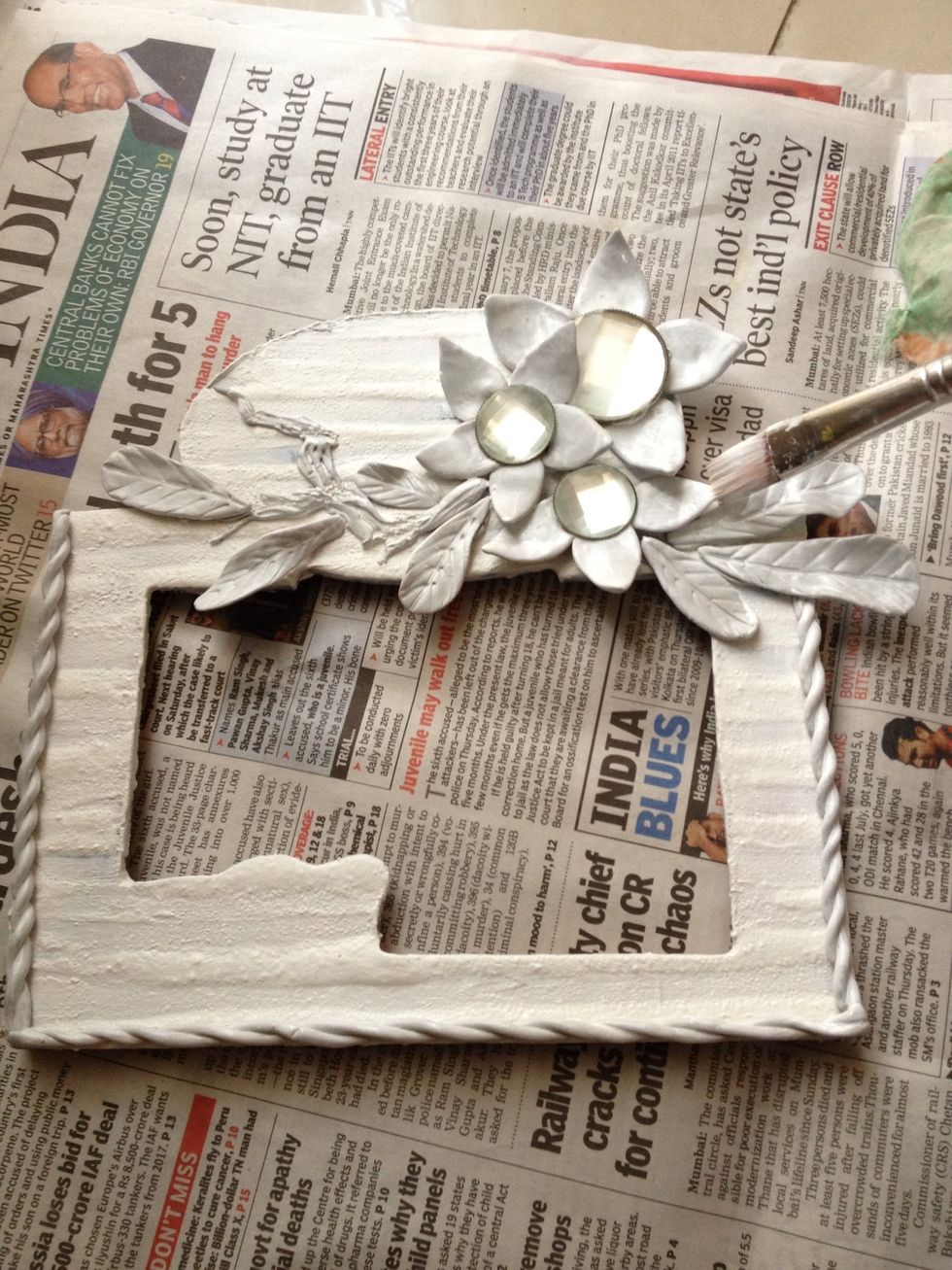 I'm gonna first apply white acrylic paint to the entire frame. This serves as a base coat and makes it easier to paint on. One coat will do.