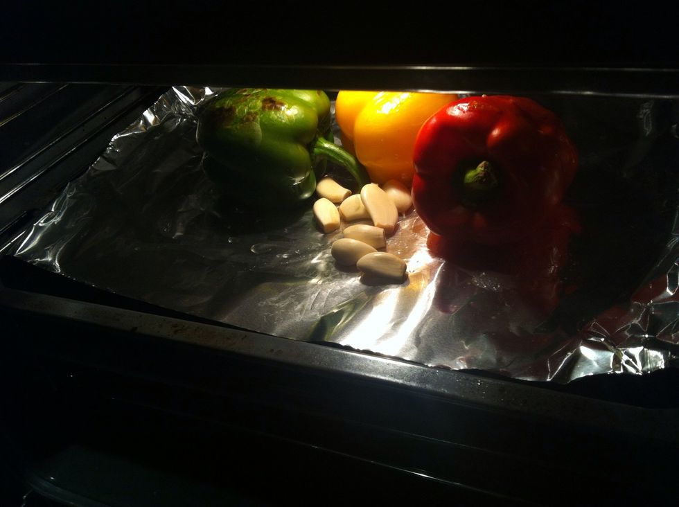 I'm peeling them for salad so I add garlic to be roasted As u can see the green one starting to burn don't be panic let it burn like usher...