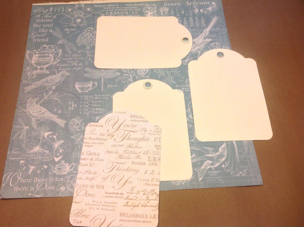 I'm starting out with graphic 45 staples ivory tags. I'm tracing them onto the Botanical Tea paper.