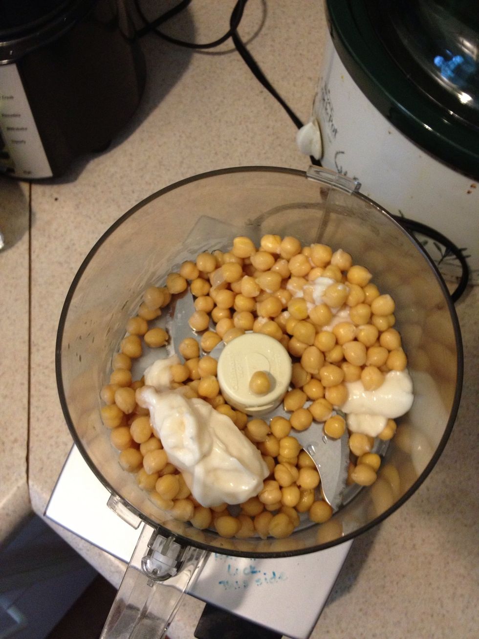 I'm using a food processor but you can use a potato masher or even a fork. Here I've put in my WELL RINSED garbanzos and mayo (Miracle Whip truth be told).