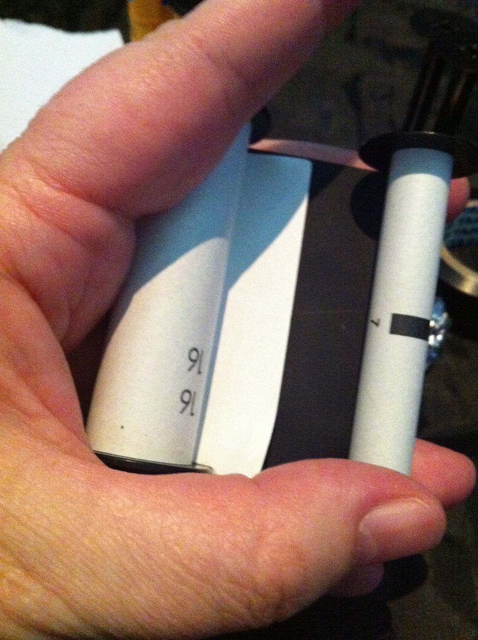 I'm using a piece of paper to show you , the film end will be loose like this.. Feel for it. The roll carefully tucking the film in.