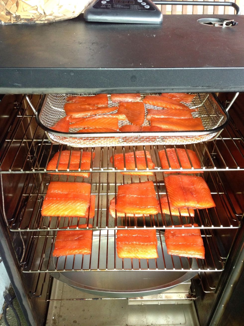 I'm using an electric smoker for this but you can do this in a grill if you know how to smoke with it. Larger pieces toward the bottom and the small ones on the very top.