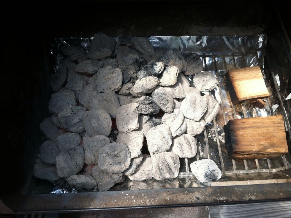 I'm using an offset firebox on my smoker. Once the charcoal is ready, place hickory wood blocks off to one side. This will help slow smoke the chicken preventing them from being too smoky and bitter.