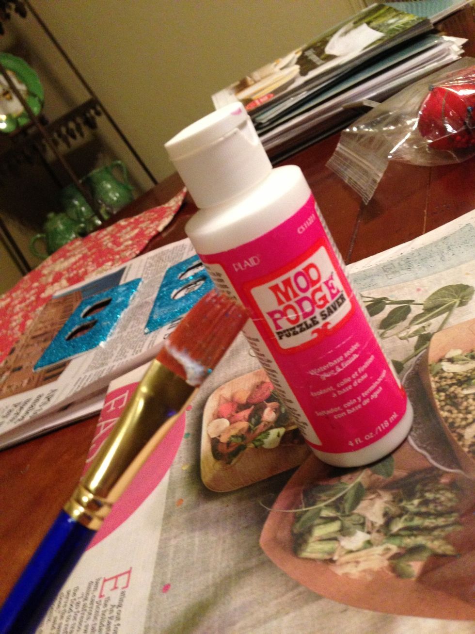 I'm using the puzzle saver modge podge because I couldn't find my normal modge podge but you can use any type. Also, I'm using a flat, wide paintbrush but foam brushes will work as well.